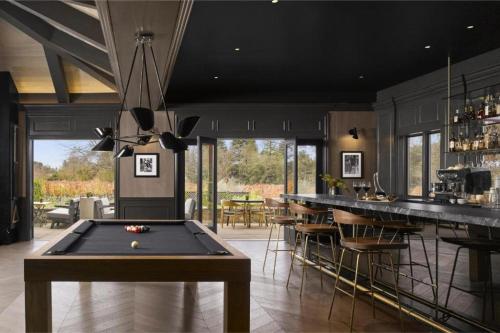 a room with a pool table and a bar at The Estate Yountville in Yountville