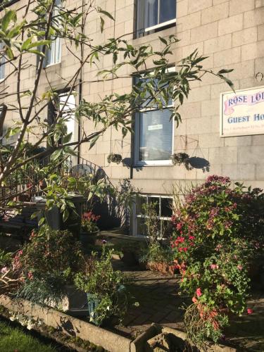 a building with flowers in front of a window at Roselodge Guest House in Aberdeen
