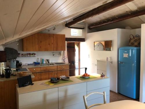 a kitchen with a blue refrigerator and a counter at Ferienhaus Turilji in Albinen