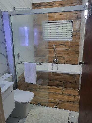 a bathroom with a tub and a toilet and a sink at Eden Wilds 38 in Port Edward