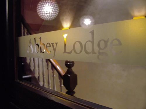 a sign in front of a mirror at The Abbey Lodge Hotel in Bradford