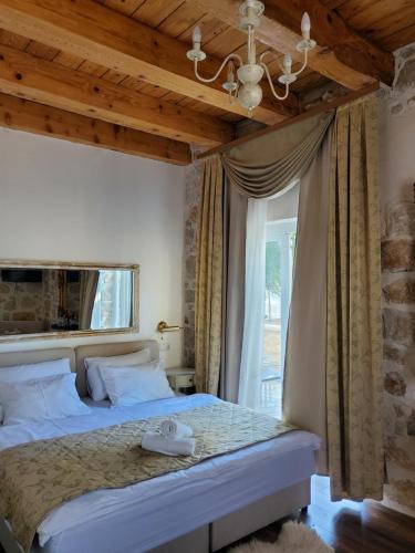 sypialnia z dużym łóżkiem i oknem w obiekcie Boutique Vila Marijini Dvori w mieście Tribunj