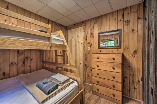 a bedroom with bunk beds in a wooden cabin at Rustic Clint Eastwood Ranch Apt by Raystown Lake in Huntingdon