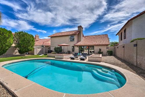 a swimming pool in front of a house at Private Pool, Gas Grill Chic Glendale Home! in Glendale
