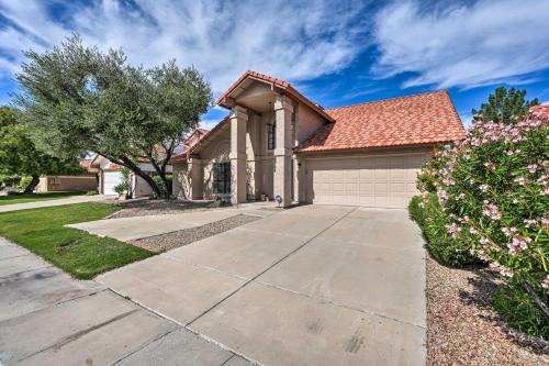 a house with a driveway and a tree at Private Pool, Gas Grill Chic Glendale Home! in Glendale