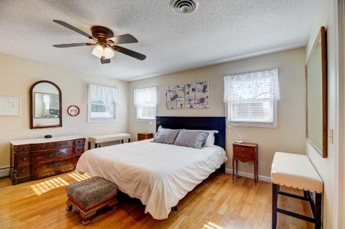 a bedroom with a bed and a ceiling fan at House of Art Group Escape By Parks and Lake! in Winooski