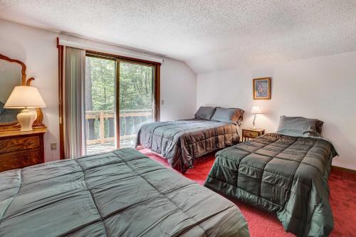 a bedroom with two beds and a window at Charming Gaylord Getaway about 2 Mi to Golfing in Gaylord