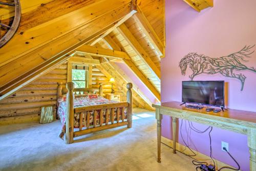 a bedroom in a log cabin with a bed and a desk at Calhoun Cabin with River View and Wraparound Deck in Calhoun