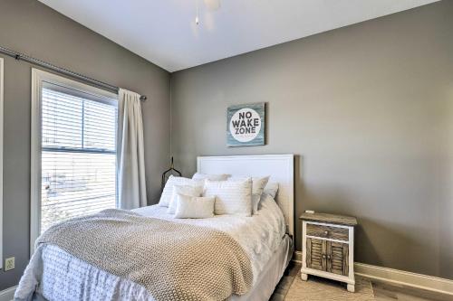 a bedroom with a bed and a window at Dtwn Ludington Condo Balcony, Walk To Beach! in Ludington