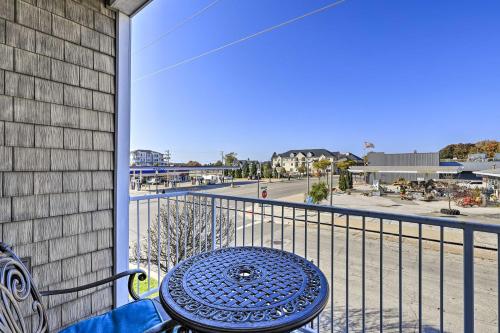 a table on a balcony with a view of a street at Dtwn Ludington Condo Balcony, Walk To Beach! in Ludington
