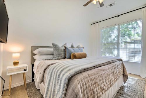 a bedroom with a large bed with a window at Modern and Chic Gulfport Escape Walk to Beach! in Gulfport
