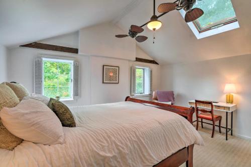 a bedroom with a bed and a desk and windows at Historic Home in Lambertville Walk to Bridge in Lambertville