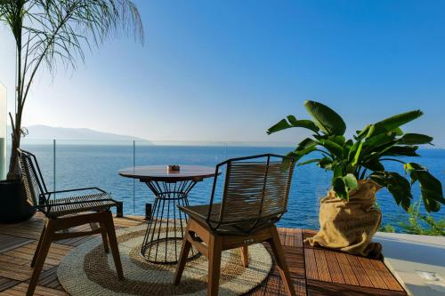 a patio with a table and chairs and the ocean at Hotel Miramare in Vlorë