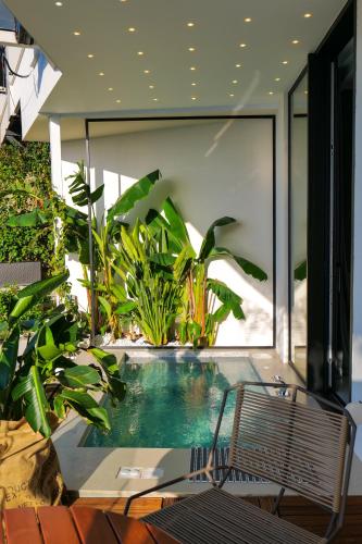 a swimming pool in a house with plants at Hotel Miramare in Vlorë