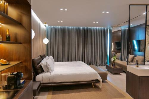 a bedroom with a bed and a bathroom with a sink at Hotel Miramare in Vlorë