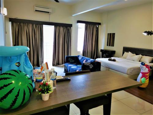 a living room with a table and a bed at HomeStay at Melaka # Free WiFi # Water ThemePark Tickets in Malacca