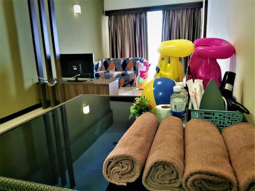 a bathroom with towels on a counter in a room at HomeStay at Melaka # Free WiFi # Water ThemePark Tickets in Melaka