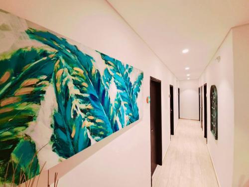 a hallway with a large painting on the wall at Summer House Inn San Andres in San Andrés