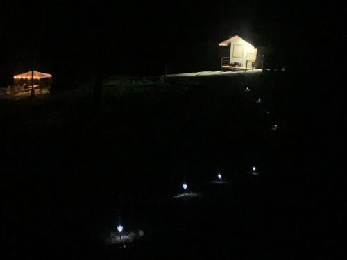 a house at night with lights in the dark at Cabañas del Bosque in Nandayure