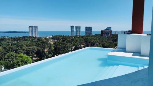 a swimming pool with a view of the city at Apartamento Acapulco Roosevelt in Punta del Este