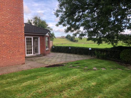 a brick house with a brick yard and a building at Stunning 5-Bed House in Clones in Cluain Eois