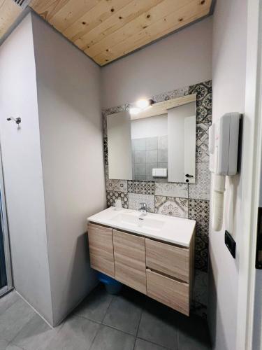 a bathroom with a sink and a mirror at hotel garni Santa Caterina in Orta San Giulio