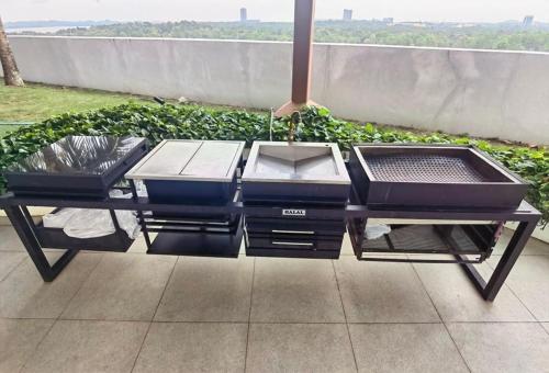 a table with three trays on a patio at Almas Suites 银河空间 Netflix BySTAY in Nusajaya