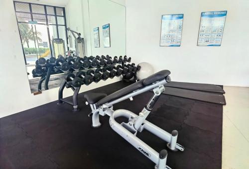 a gym with a row of weights at Almas Suites 银河空间 Netflix BySTAY in Nusajaya
