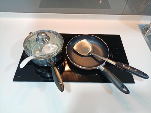 a counter top with utensils and a frying pan and spoon at Almas Suites 银河空间 Netflix BySTAY in Nusajaya
