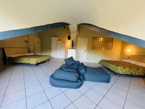 a room with two beds and a couch in it at hotel garni Santa Caterina in Orta San Giulio