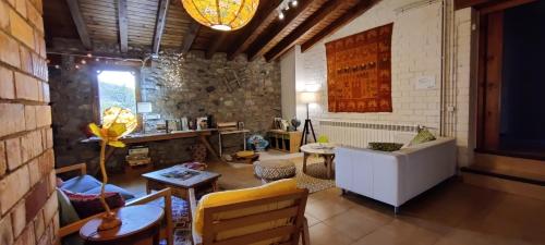 uma sala de estar com um sofá e uma mesa em Alberg Rural La Rectoria de Pedra em Bellver de Cerdanya 