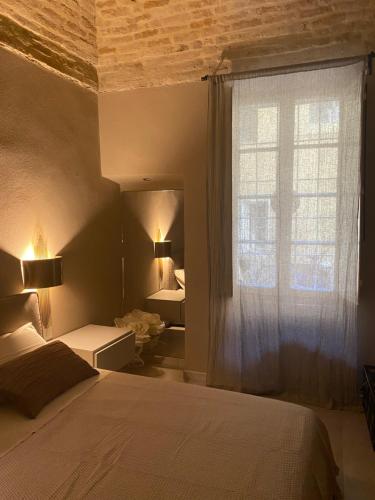 a bedroom with a large bed and a window at Parma Centro House in Parma