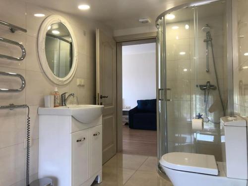 a bathroom with a toilet and a sink and a shower at Marių įlanka in Marijampolė
