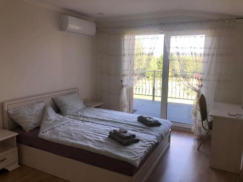 a bedroom with a bed with two shoes on it at Marių įlanka in Marijampolė