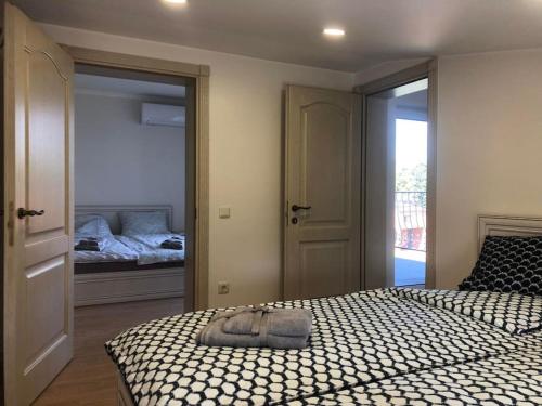 a bedroom with a bed and a bedroom with a mirror at Marių įlanka in Marijampolė