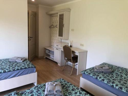 a bedroom with two beds and a desk and a deskablish at Marių įlanka in Marijampolė