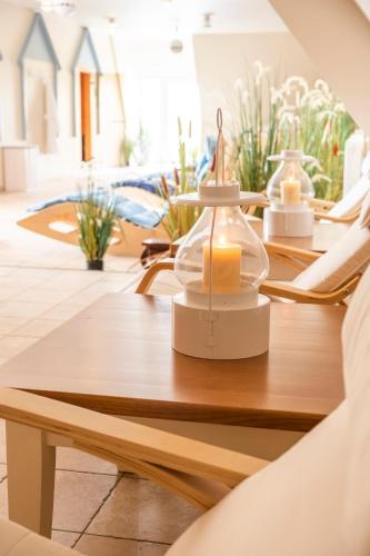 a wooden table with a candle on top of it at Hotel, Restaurant, Café Pharisäerhof - Nordseeurlaub mit Hund in Nordstrand