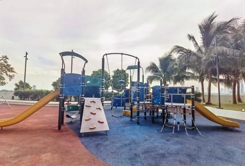 a playground with a slide and a slidesktop at Almas Suites Ruang Galaksi Netflix oleh STAY in Nusajaya