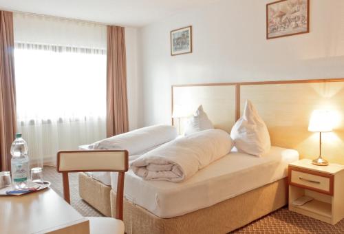 Postel nebo postele na pokoji v ubytování Hotel Ganita Weil am Rhein