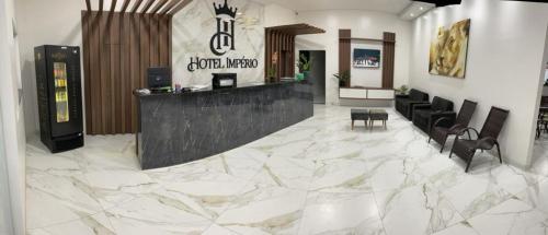 a lobby with a marble floor and a bar at HOTEL IMPERIO in Aparecida do Taboado