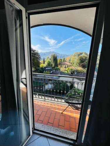 an open door to a balcony with a view at hotel garni Santa Caterina in Orta San Giulio