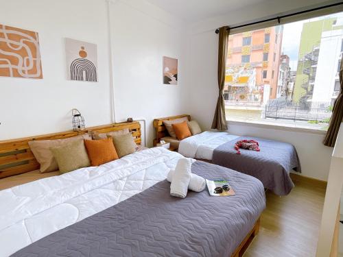 a bedroom with two beds and a window at Lively and cozy canal house ,Entire house in Bangkok