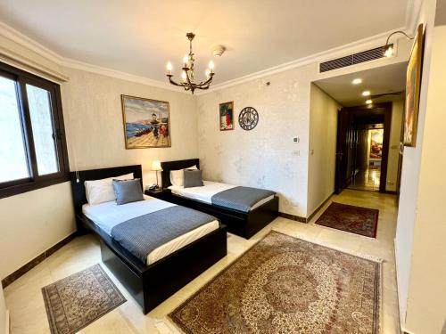 a bedroom with a bed and a bench in it at Luxury hotel apartment with pools in front AUC in Cairo