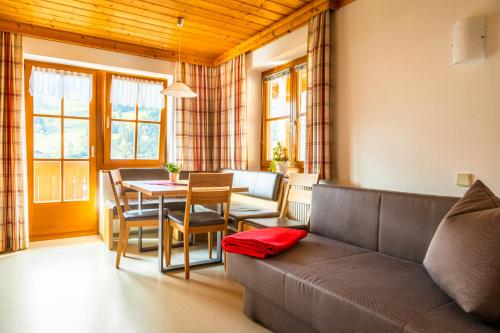 a living room with a couch and a table at Haus Kathrin in Dorfgastein
