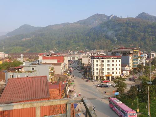 a view of a city with a mountain in the background at Minh Hưng Hostel in Sa Pa