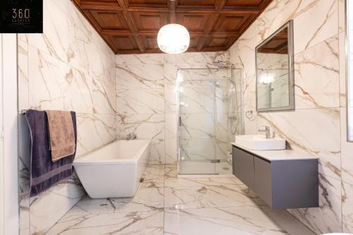 a bathroom with a sink and a toilet and a shower at Palazzo 16th Century Mdina, opposite St Paul's Cathedral by 360 Estates in Mdina