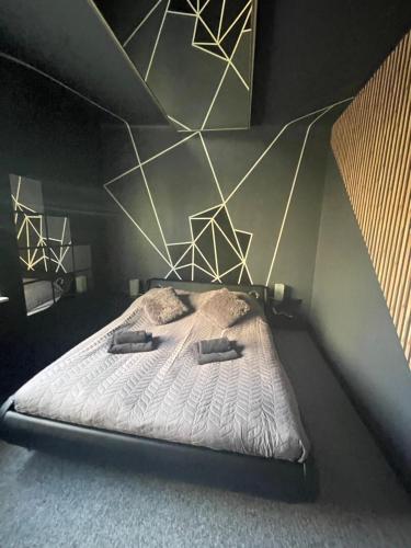 a bedroom with a bed with two pillows on it at Apartamenty Konopnicka in Bydgoszcz