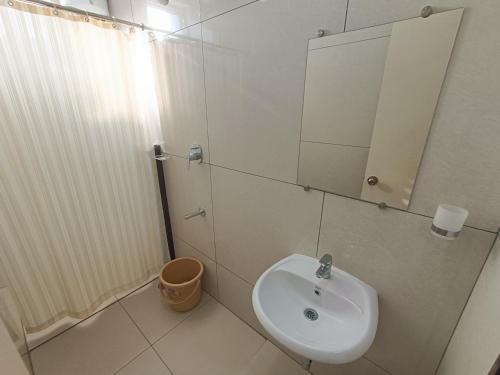 a bathroom with a sink and a mirror at Sri Aswin Grand in Nāmakkal