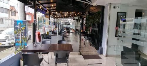a restaurant with a table and chairs on a street at Blue House Corferias in Bogotá