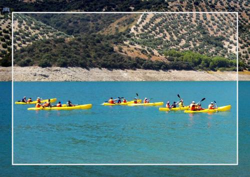 a group of people in kayaks on a body of water at El Rincon de Carmen in Rute